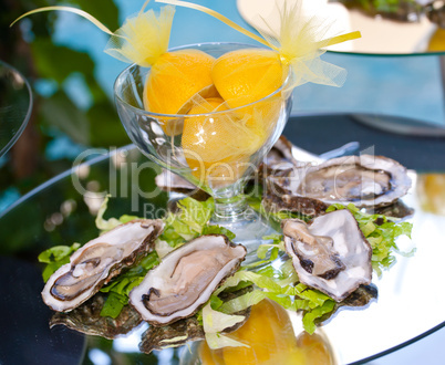 Oysters with lemons on mirror table