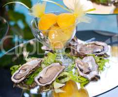 Oysters with lemons on mirror table