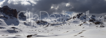 Panorama of snowy mountains before storm