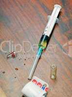 Syringe with medicine on wooden table