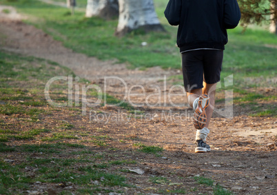 Man running cross country on trail