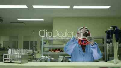 Biotech and pharmaceutical laboratory, employee wearing mask, checking vaccine