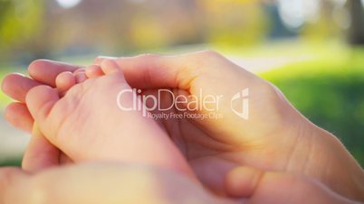 Close up Gentle Hands Cradling Baby Foot