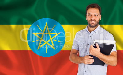 Male student of languages ??on Ethiopian flag