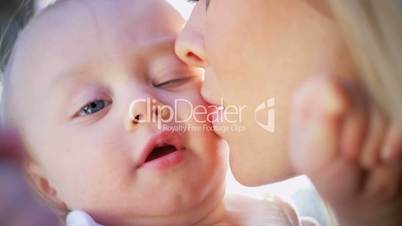 Mothers Tender Kiss for Baby