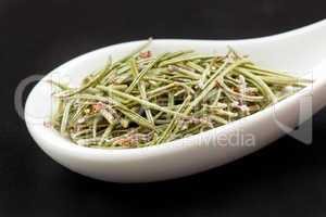 Rosemary in white spoon