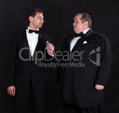 Two stylish businessman in tuxedos
