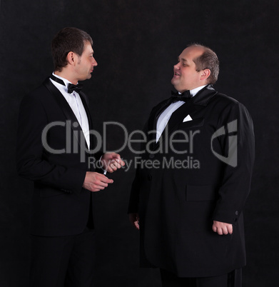 Two stylish businessman in tuxedos