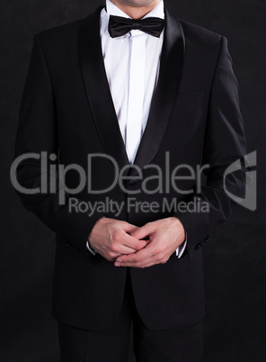 Stylish man in elegant black tuxedo