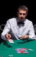 Gentleman in white shirt, playing cards