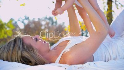 Blonde Mom and Baby Together Outdoors