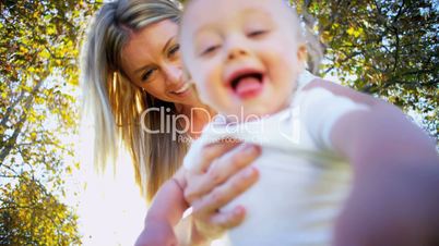 Cute Baby and Mom Playing Outdoors