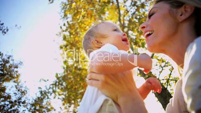Blonde Mom and Baby Laughing Outdoors