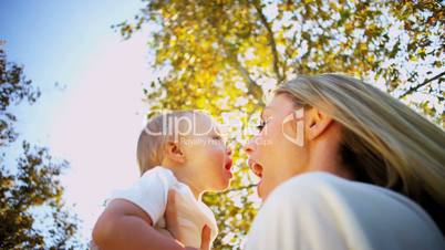 Caucasian Mother and Baby Tender Kiss