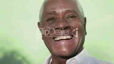 Portrait of senior black man looking at camera and laughing