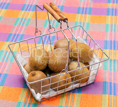 basket of kiwi on tablecloth