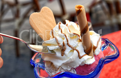 Ice cream in glass bowl with whipped cream