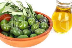 Olive oil and branches of an olive tree