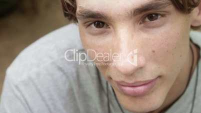 Happy young caucasian man looking at camera and smiling