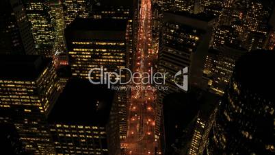 Aerial night illuminated view of skyscrapers, rooftops, USA