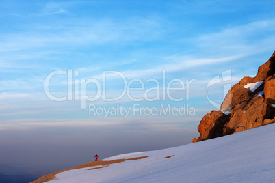 Hiker in sunrise mountains