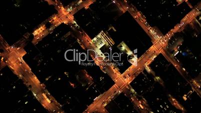 Aerial night vertical city view of rolling road grid system, USA