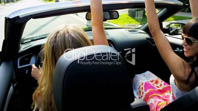 Friends Having Fun Driving Open Top Car