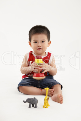 Young kid playing with colorful toys