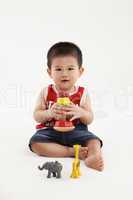 Young kid playing with colorful toys