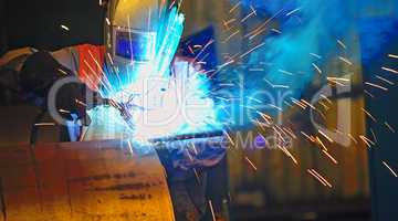 worker with protective mask welding metal