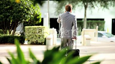 Businessman on Smart Phone with Travel Luggage