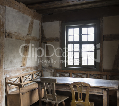 rustic chamber with bench, table and chair.