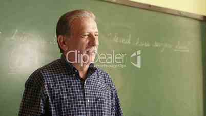 Education, teacher explaining lesson to students during class in college
