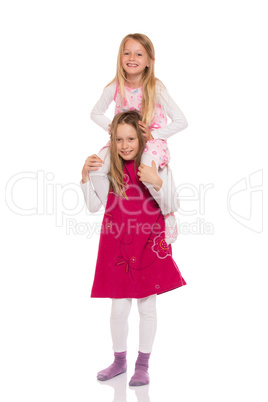 Young girl giving piggyback ride