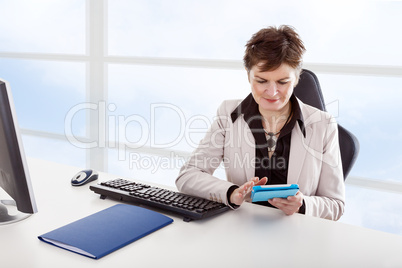 Businesswoman in office with tablet PC