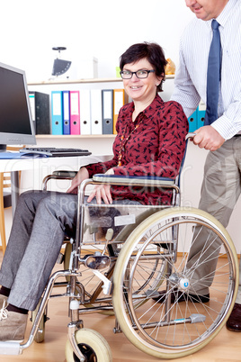 Woman in wheelchair can help in Office