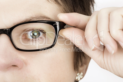Woman holds her glasses