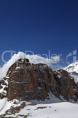 Rocks in snow and blue sky