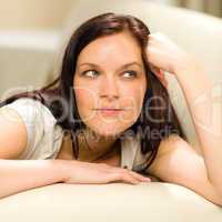 Thinking pensive woman lying in living room