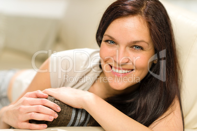 Serene cheerful woman lying on couch