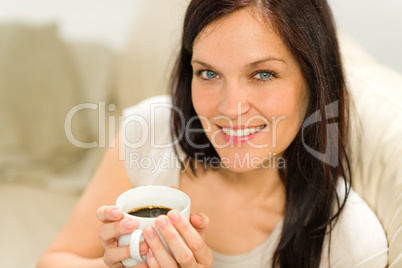 Smiling satisfied woman holding cup of espresso