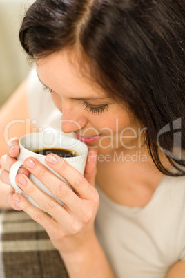 Relaxing woman drinking hot beverage for enjoyment