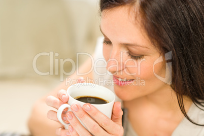 Cute woman holding cup of hot coffee