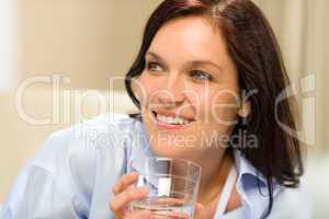 Smiling brunette woman with glass of water