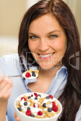 Portrait of happy woman eating cereal