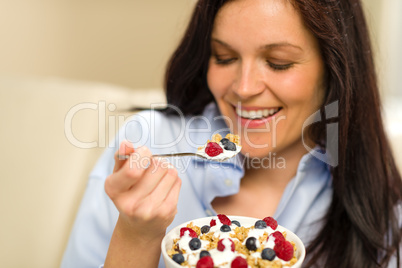 Relaxed woman eating cereal for breakfast