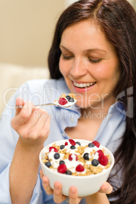 Dieting woman eating healthy cereal for breakfast