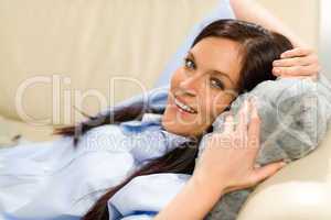 Happy woman resting lying on couch