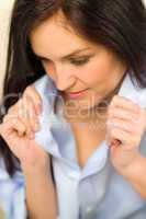 Close up of woman adjusting her shirt