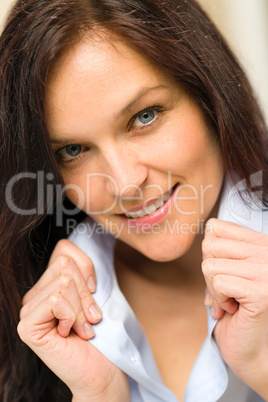 Confident woman holding her shirt's collar